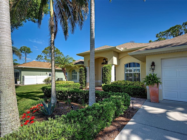 237 Rotonda Blvd E, Rotonda West, FL 33947 - view of front of home with stucco siding, fence, and a shingled roof