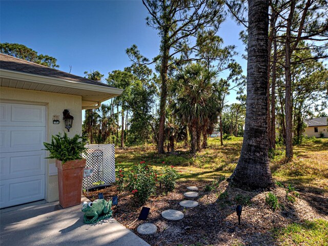 237 Rotonda Blvd E, Rotonda West, FL 33947 - view of yard featuring a garage
