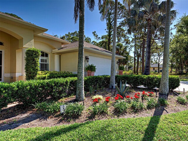 237 Rotonda Blvd E, Rotonda West, FL 33947 - view of side of property featuring stucco siding and a garage