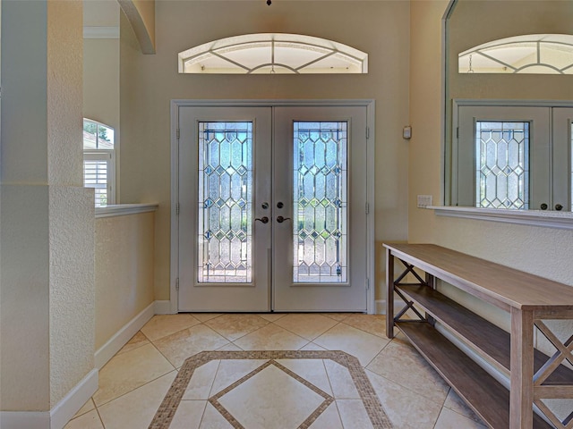 237 Rotonda Blvd E, Rotonda West, FL 33947 - foyer with french doors, baseboards, inlaid floor details, and tile patterned floors