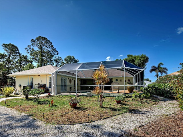 237 Rotonda Blvd E, Rotonda West, FL 33947 - view of front facade featuring a patio, stucco siding, a lanai, and a swimming pool