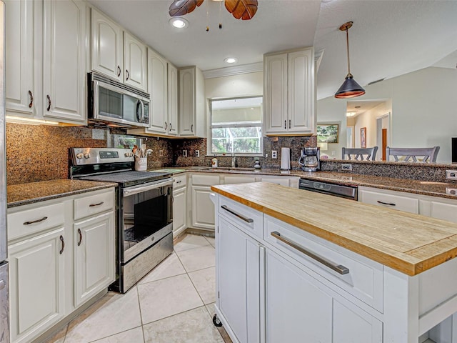 237 Rotonda Blvd E, Rotonda West, FL 33947 - kitchen with stainless steel appliances, wooden counters, tasteful backsplash, and a sink