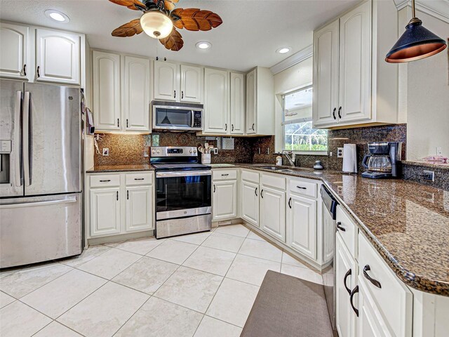 237 Rotonda Blvd E, Rotonda West, FL 33947 - kitchen with appliances with stainless steel finishes, light tile patterned floors, ceiling fan, a sink, and pendant lighting