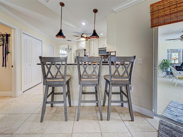 237 Rotonda Blvd E, Rotonda West, FL 33947 - kitchen featuring a ceiling fan, appliances with stainless steel finishes, ornamental molding, a peninsula, and baseboards