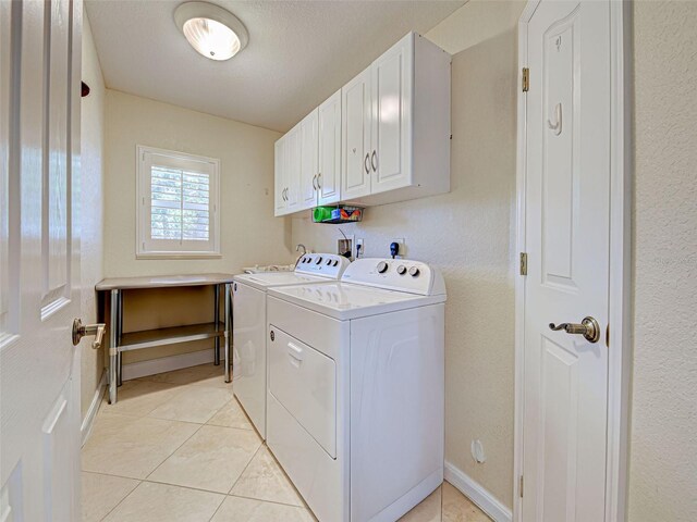 237 Rotonda Blvd E, Rotonda West, FL 33947 - clothes washing area with cabinet space, washing machine and dryer, and light tile patterned floors