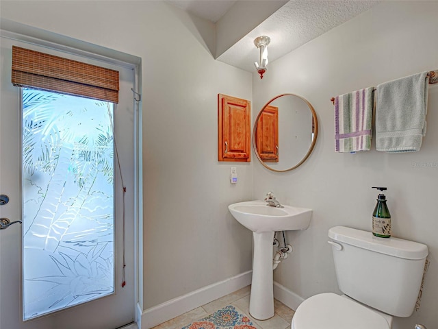 237 Rotonda Blvd E, Rotonda West, FL 33947 - bathroom featuring baseboards, toilet, tile patterned floors, and a sink