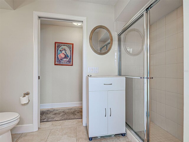 237 Rotonda Blvd E, Rotonda West, FL 33947 - full bath featuring a stall shower, toilet, tile patterned flooring, and baseboards