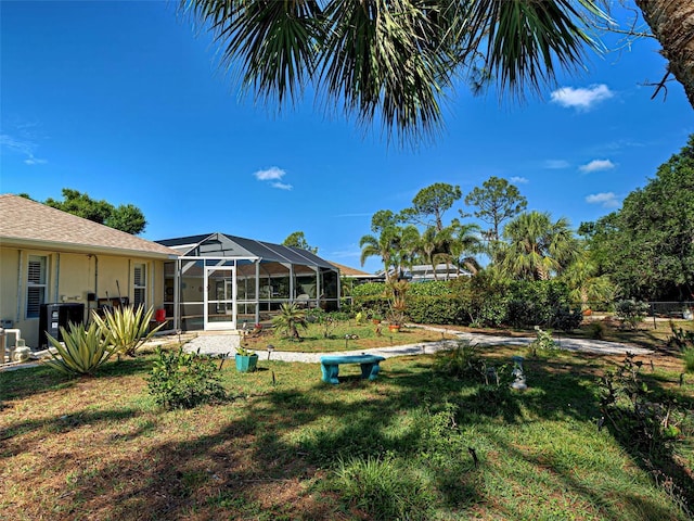237 Rotonda Blvd E, Rotonda West, FL 33947 - view of grassy yard featuring central air condition unit and a lanai