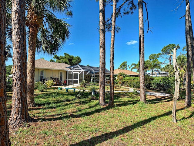237 Rotonda Blvd E, Rotonda West, FL 33947 - view of grassy yard featuring glass enclosure