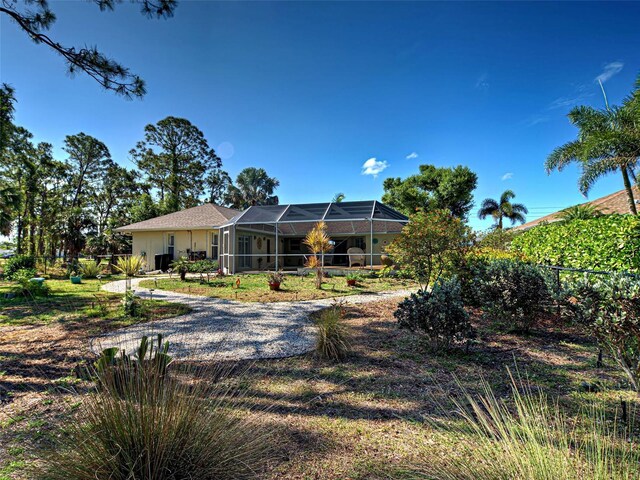 237 Rotonda Blvd E, Rotonda West, FL 33947 - rear view of property with a lanai and fence