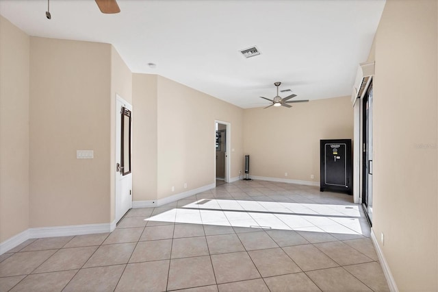 unfurnished room featuring a ceiling fan, light tile patterned floors, and baseboards
