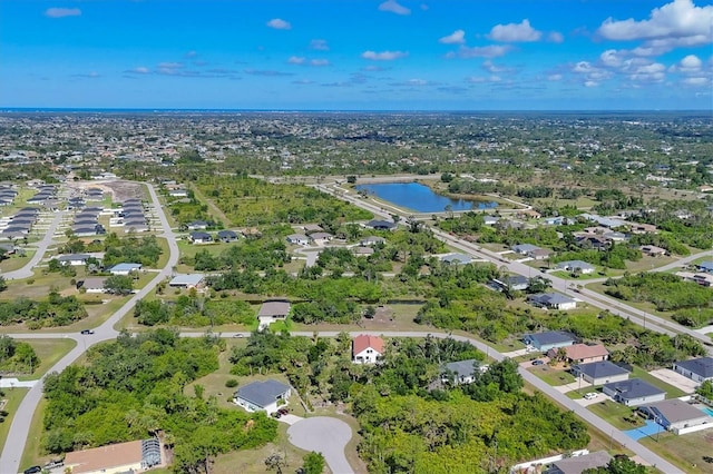 view of property location with a nearby body of water and nearby suburban area