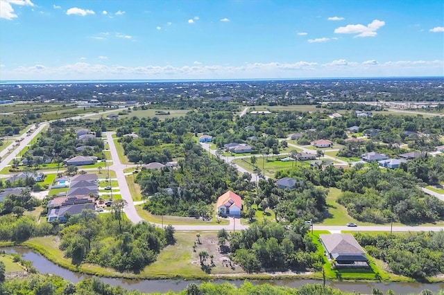 bird's eye view of a nearby body of water and a tree filled landscape