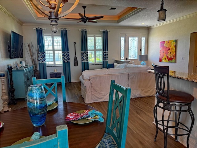 174 Broadmoor Ln, Rotonda West, FL 33947 - dining room with crown molding, a ceiling fan, wood finished floors, a textured ceiling, and a raised ceiling