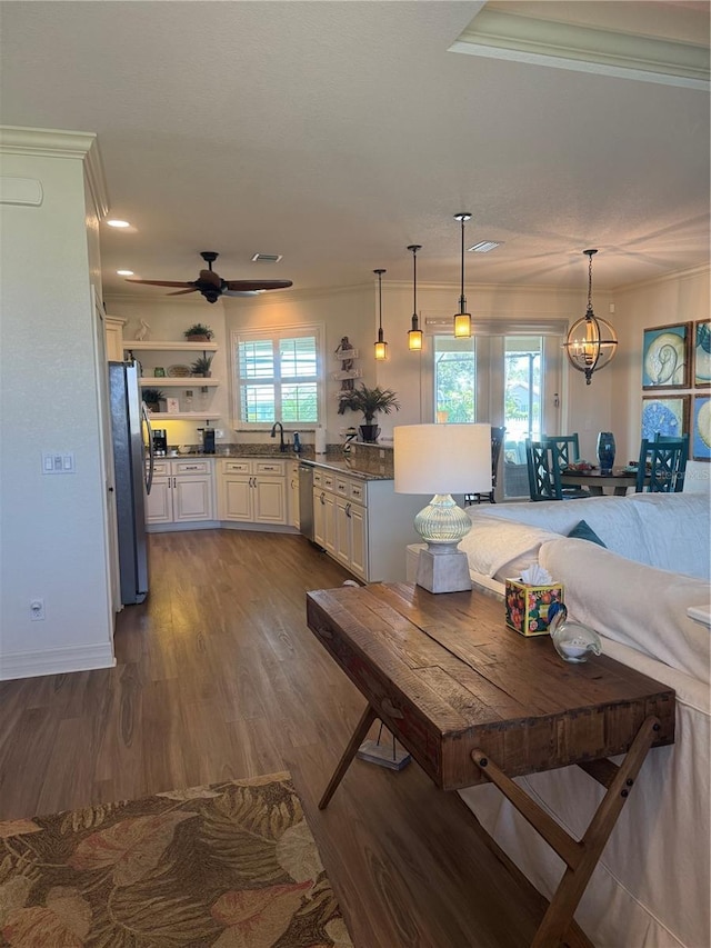 174 Broadmoor Ln, Rotonda West, FL 33947 - dining area with dark wood-style floors, a ceiling fan, and crown molding