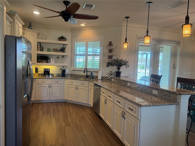 174 Broadmoor Ln, Rotonda West, FL 33947 - kitchen featuring appliances with stainless steel finishes, a peninsula, a ceiling fan, dark wood-style flooring, and open shelves