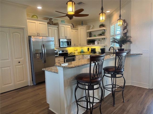 174 Broadmoor Ln, Rotonda West, FL 33947 - kitchen with appliances with stainless steel finishes, crown molding, a peninsula, a kitchen breakfast bar, and a ceiling fan