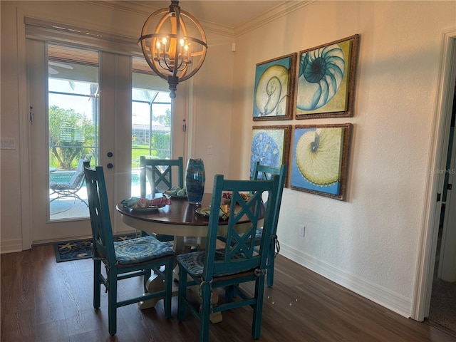 174 Broadmoor Ln, Rotonda West, FL 33947 - dining space with dark wood-type flooring, french doors, a chandelier, and crown molding