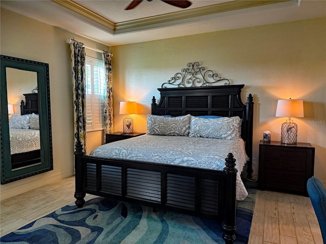 174 Broadmoor Ln, Rotonda West, FL 33947 - bedroom featuring ornamental molding, a raised ceiling, wood finished floors, and a ceiling fan