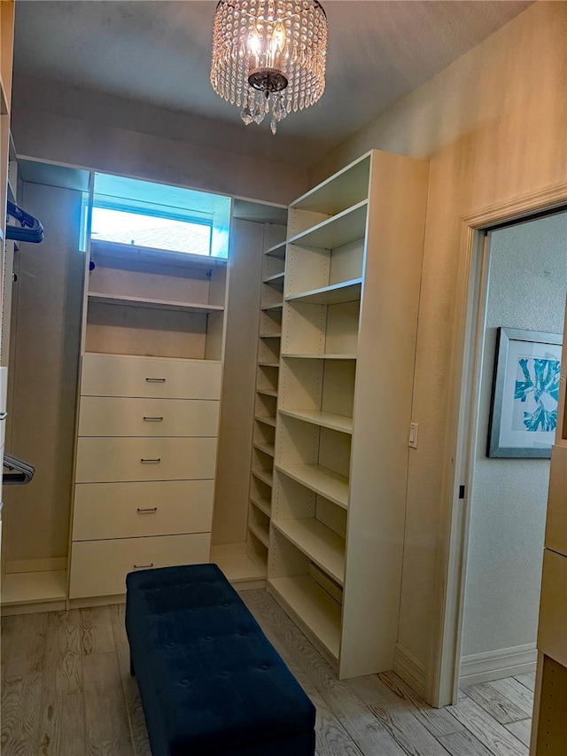 174 Broadmoor Ln, Rotonda West, FL 33947 - spacious closet featuring light wood-style floors and a chandelier