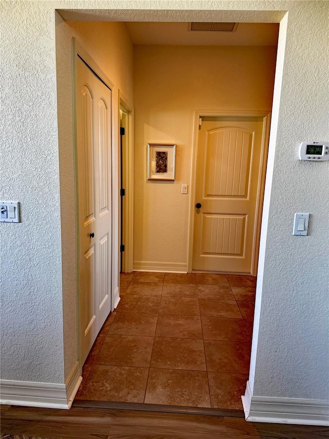 174 Broadmoor Ln, Rotonda West, FL 33947 - hall featuring a textured wall and tile patterned flooring