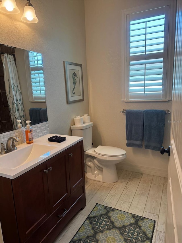 174 Broadmoor Ln, Rotonda West, FL 33947 - bathroom with vanity, wood finished floors, decorative backsplash, and a shower with curtain
