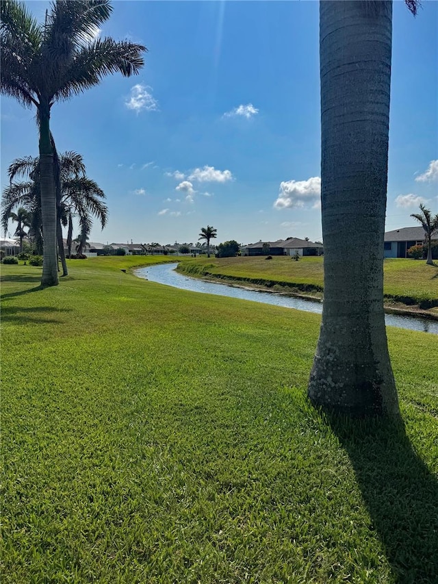 174 Broadmoor Ln, Rotonda West, FL 33947 - view of home's community with a water view and a yard