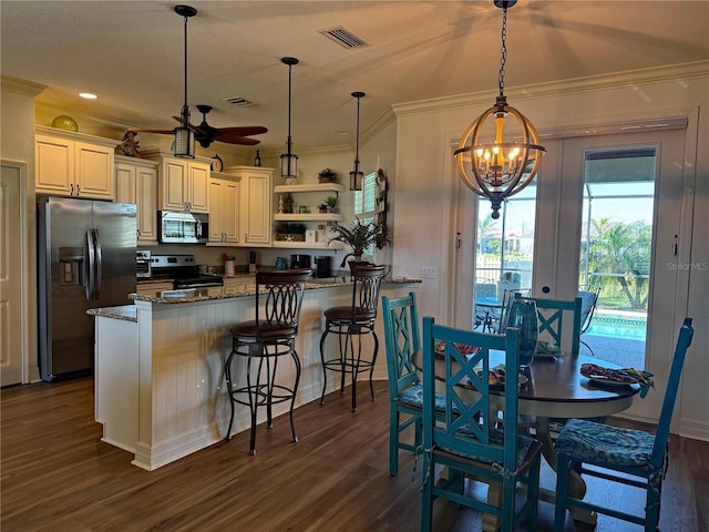 174 Broadmoor Ln, Rotonda West, FL 33947 - kitchen featuring stainless steel appliances, a chandelier, open shelves, healthy amount of natural light, and crown molding