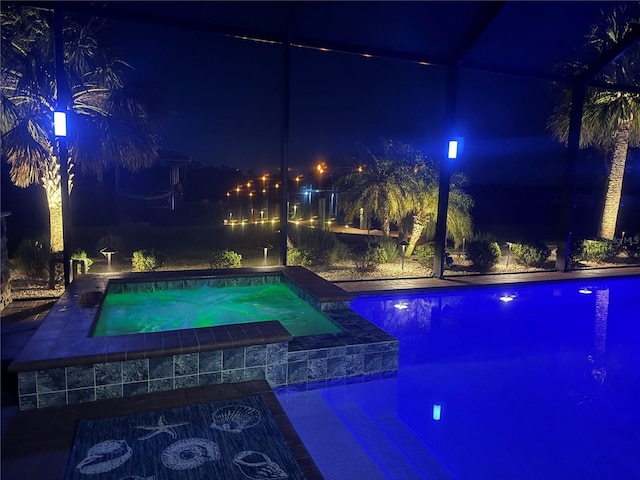 174 Broadmoor Ln, Rotonda West, FL 33947 - pool at twilight featuring an in-ground hot tub and an outdoor pool