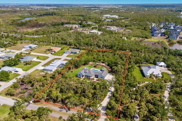 9144 Spring Valley Rd, Englewood, FL 34224 - aerial view of residential area featuring property parcel outlined, a nearby body of water, and a heavily wooded area