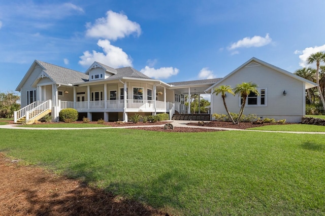 9144 Spring Valley Rd, Englewood, FL 34224 - country-style home featuring a porch, a front yard, and roof with shingles