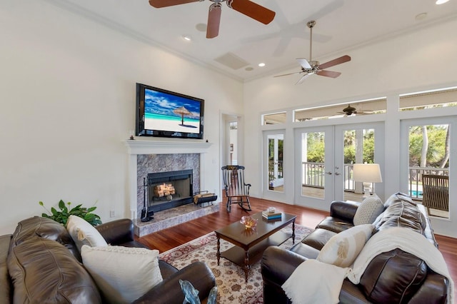 9144 Spring Valley Rd, Englewood, FL 34224 - living area featuring ceiling fan, ornamental molding, french doors, wood finished floors, and a high end fireplace
