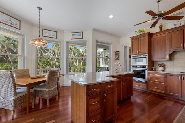 9144 Spring Valley Rd, Englewood, FL 34224 - kitchen featuring dark wood-style floors, tasteful backsplash, crown molding, a ceiling fan, and a sink