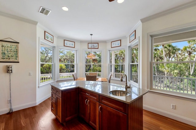 9144 Spring Valley Rd, Englewood, FL 34224 - kitchen featuring a sink, baseboards, plenty of natural light, light stone countertops, and crown molding