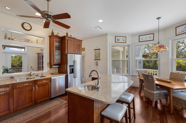 9144 Spring Valley Rd, Englewood, FL 34224 - kitchen featuring a sink, stainless steel appliances, brown cabinetry, crown molding, and glass insert cabinets