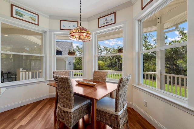 9144 Spring Valley Rd, Englewood, FL 34224 - dining area with wood finished floors, a chandelier, baseboards, and ornamental molding