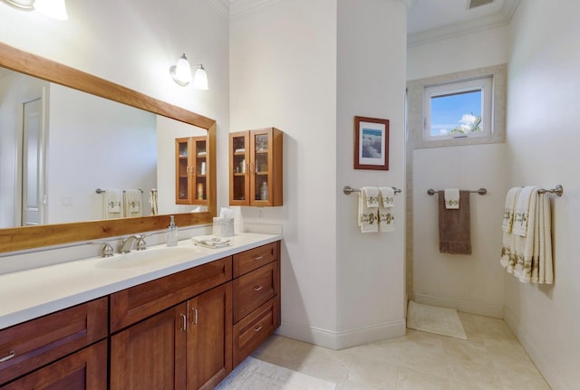 9144 Spring Valley Rd, Englewood, FL 34224 - bathroom with ornamental molding, baseboards, vanity, and tile patterned floors