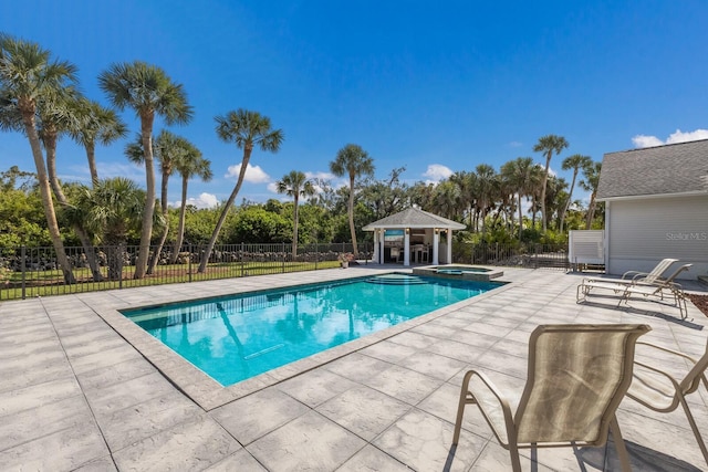 9144 Spring Valley Rd, Englewood, FL 34224 - view of pool featuring a gazebo, a patio area, fence, view of scattered trees, and a pool with connected hot tub
