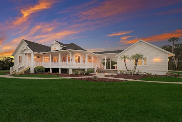 9144 Spring Valley Rd, Englewood, FL 34224 - view of front of home featuring covered porch, a front lawn, and stairway