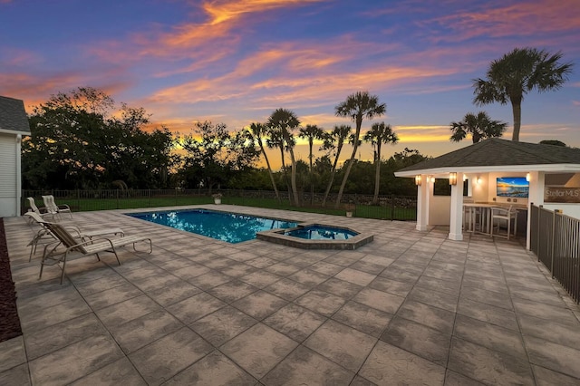 9144 Spring Valley Rd, Englewood, FL 34224 - pool at dusk with a patio, fence, and a pool with connected hot tub