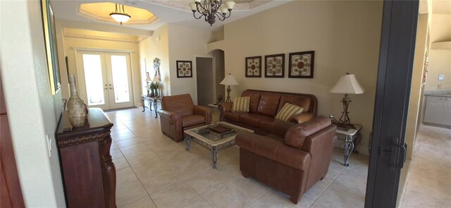 19 Medalist Way, Rotonda West, FL 33947 - living area with french doors, a chandelier, light tile patterned floors, arched walkways, and a tray ceiling
