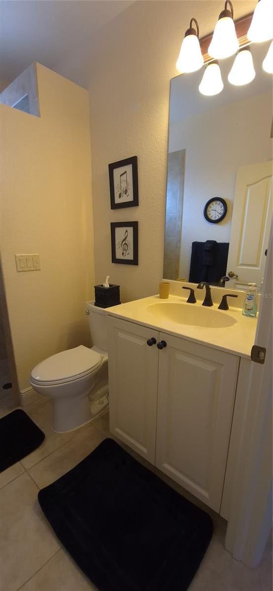 19 Medalist Way, Rotonda West, FL 33947 - bathroom with tile patterned floors, toilet, and vanity