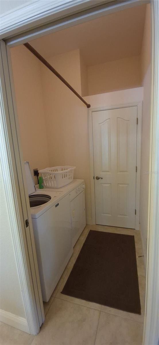 19 Medalist Way, Rotonda West, FL 33947 - washroom featuring washer and clothes dryer and light tile patterned floors