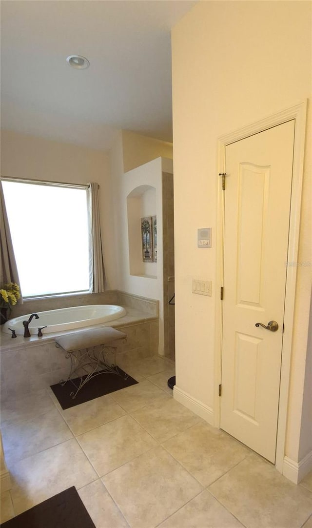 19 Medalist Way, Rotonda West, FL 33947 - full bathroom with tile patterned flooring, a bath, and baseboards