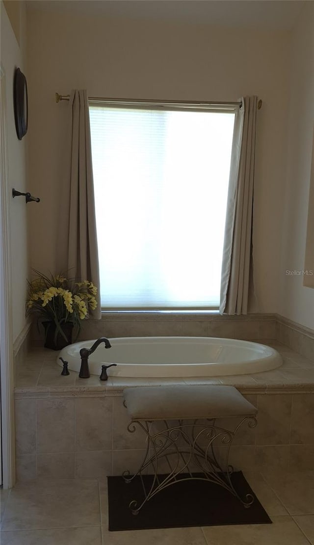 19 Medalist Way, Rotonda West, FL 33947 - full bath featuring healthy amount of natural light, tile patterned flooring, and a garden tub