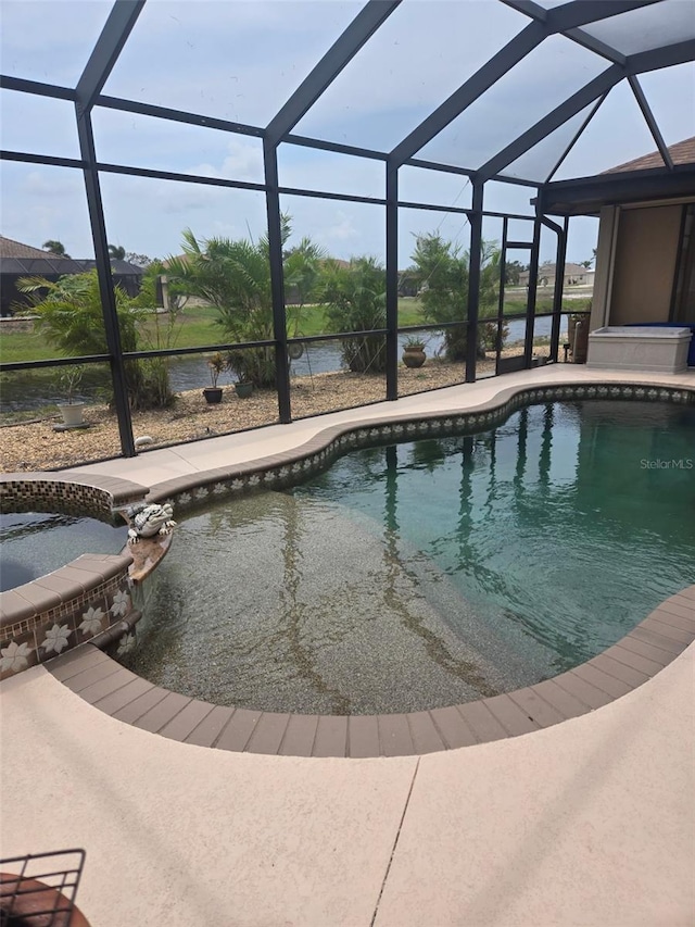 19 Medalist Way, Rotonda West, FL 33947 - view of pool featuring a lanai, a patio area, a pool with connected hot tub, and a water view