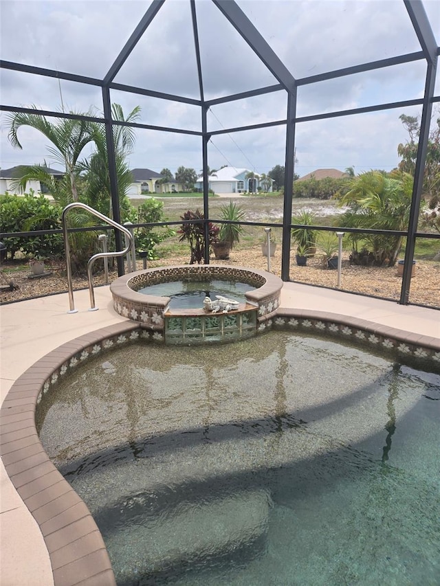 19 Medalist Way, Rotonda West, FL 33947 - view of swimming pool featuring a pool with connected hot tub and a lanai