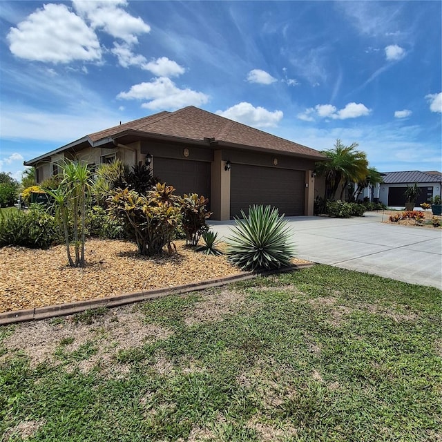 19 Medalist Way, Rotonda West, FL 33947 - view of front of house featuring an attached garage, concrete driveway, and stucco siding