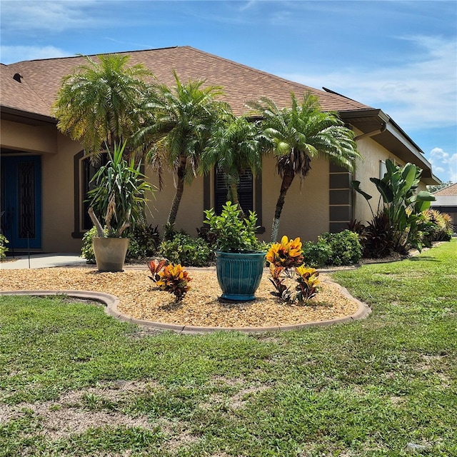 19 Medalist Way, Rotonda West, FL 33947 - view of side of property featuring stucco siding and a lawn