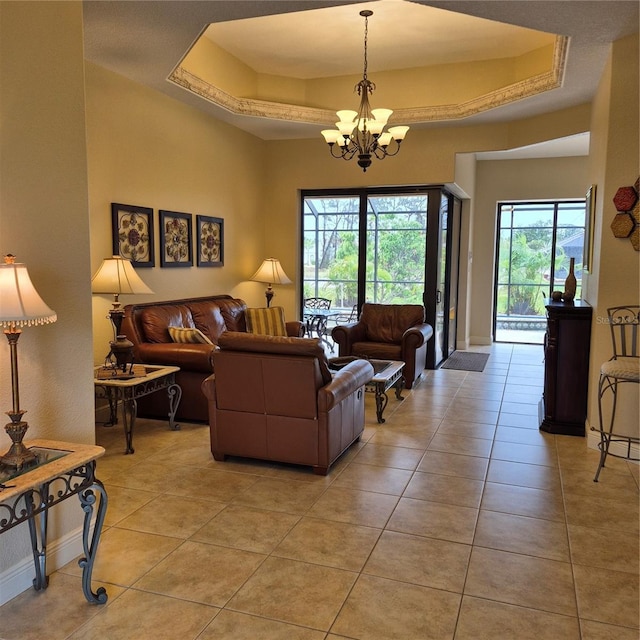19 Medalist Way, Rotonda West, FL 33947 - living room featuring a chandelier, light tile patterned flooring, and a raised ceiling